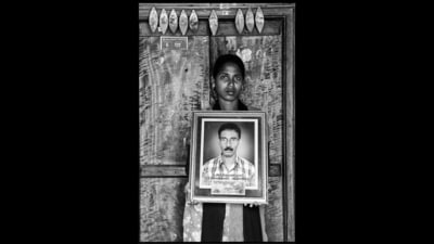 V Mary holds up an image of her late father, Anthony Swamy. This is from the award-winning First Witnesses series that uses the frame-within-a-frame to memorialise Indian farmers who have died by suicide, and their loved ones. (Photo: Vijay S Jodha) V Mary holds up an image of her late father, Anthony Swamy. This is from the award-winning First Witnesses series that uses the frame-within-a-frame to memorialise Indian farmers who have died by suicide, and their loved ones. (Photo: Vijay S Jodha)