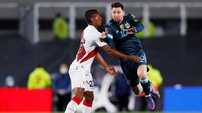 Argentina's Lionel Messi in action with Peru's Pedro Aquino (REUTERS)