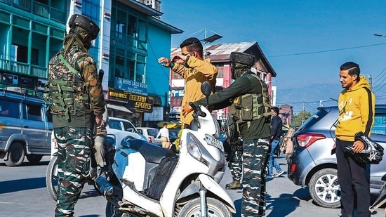 A soldier frisks a motorist along a street in Srinagar on Friday.( AFP)