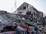 Residents stand amid the debris of a house damaged in a gun battle, in the Drangbal area of Pampore on Saturday. (AFP) Residents stand amid the debris of a house damaged in a gun battle, in the Drangbal area of Pampore on Saturday. (AFP)