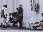Members of the Taliban sit at a checkpoint near the airport in Kabul. Members of the Taliban sit at a checkpoint near the airport in Kabul.