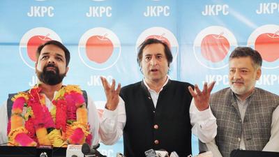 Jammu and Kashmir Peoples Conference president Sajad Gani Lone along with newly joined JKPC leader Hilal Ahmad Rather addresses a press conference in Srinagar on Saturday. (PTI)