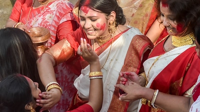 Devotees in Kolkata play ‘Sindur Khela,’ which literally translates to, 'vermillion game' on the last day of the Durga Puja festival. (PTI) Devotees in Kolkata play ‘Sindur Khela,’ which literally translates to, 'vermillion game' on the last day of the Durga Puja festival. (PTI)