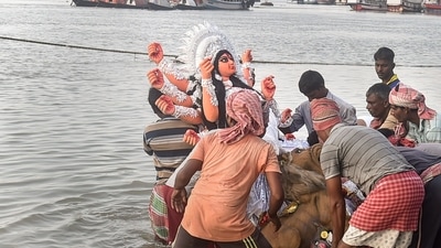 Devotees immerse an idol of Goddess Durga on the last day of Durga Puja festival at the bank of river Ganga in Kolkata. (PTI) Devotees immerse an idol of Goddess Durga on the last day of Durga Puja festival at the bank of river Ganga in Kolkata. (PTI)