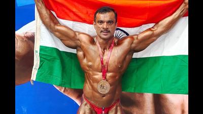 Assistant Police Inspector, Subhash Pujari, from Highway Safety Patrol in Navi Mumbai, with his bronze medal that he won a bodybuilding competition in Tashkent recently. (BACHCHAN KUMAR/HT PHOTO) Assistant Police Inspector, Subhash Pujari, from Highway Safety Patrol in Navi Mumbai, with his bronze medal that he won a bodybuilding competition in Tashkent recently. (BACHCHAN KUMAR/HT PHOTO)