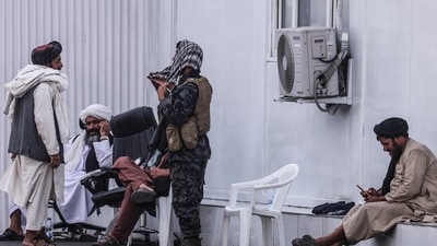 Members of the Taliban sit at a checkpoint near the airport in Kabul. (AFP) Members of the Taliban sit at a checkpoint near the airport in Kabul. (AFP)