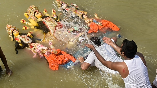 Vijayadashami marks the final day of the Durga Puja festival. On this day devotees bid goodbye to Goddess Durga by immersing the idols in water. In the North, devotees burn effigies of Ravan, Meghnad and Kumbhakaran. Here's how the people of Kolkata celebrated Vijayadashami.(PTI)