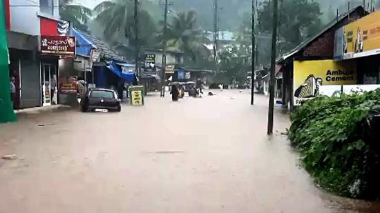 Flood water gushes through low-lying areas triggered by heavy incessant rain at Ranni, in Pathanamthitta on Saturday. (ANI PHOTO.)