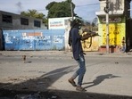 Haiti: In this Nov. 21, 2018 file photo, an armed civilian carries a weapon on during a shootout between rival gangs(File Photo / AP) Haiti: In this Nov. 21, 2018 file photo, an armed civilian carries a weapon on during a shootout between rival gangs(File Photo / AP)