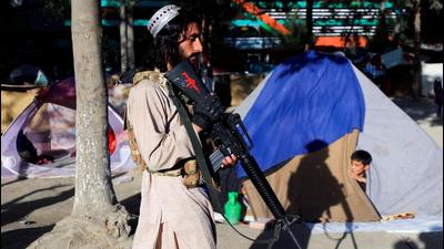 A Taliban fighter walks past the tent of a displaced family fleeing the violence in their province at Shahr-e Naw park in Kabul in Afghanistan. (Image used for representation). (REUTERS PHOTO.) A Taliban fighter walks past the tent of a displaced family fleeing the violence in their province at Shahr-e Naw park in Kabul in Afghanistan. (Image used for representation). (REUTERS PHOTO.)