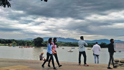 Visitors enjoying the cloudy weather at Sukhna Lake in Chandigarh on Sunday. (Keshav Singh/HT)