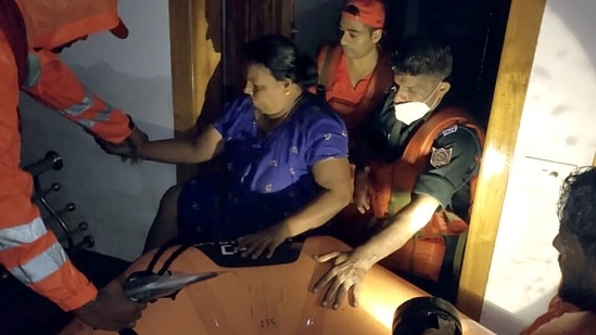 NDRF personnel take out a woman during a search and rescue operation at a flood-affected area, at Ranni, in Pathanamthitta, Kerala on October 17. (ANI )