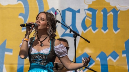 A singer performs with West Coast Prost at the Los Angeles Vegan Oktoberfest beer festival in Los Angeles on October 16, 2021.(AFP)
