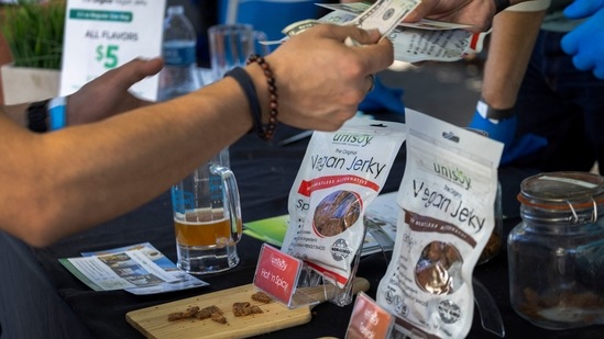 A man buys vegan jerky at the Vegan Oktoberfest beer festival in Los Angeles on October 16.(AFP)