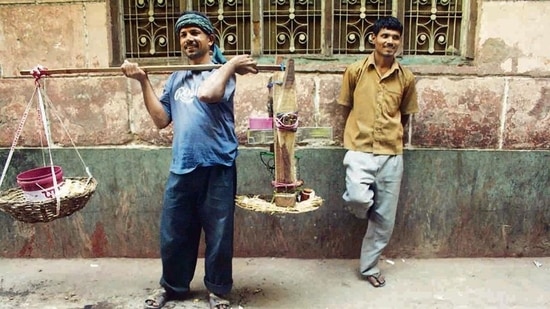 Watching Vijay walk with his baingi is evocative of a celebrated sequence in Satyajit Ray’s film Pather Panchali in which a similar mithai seller ambles along with his yoked sweets, greedily followed by two children and a dog. Watching Vijay walk with his baingi is evocative of a celebrated sequence in Satyajit Ray’s film Pather Panchali in which a similar mithai seller ambles along with his yoked sweets, greedily followed by two children and a dog.