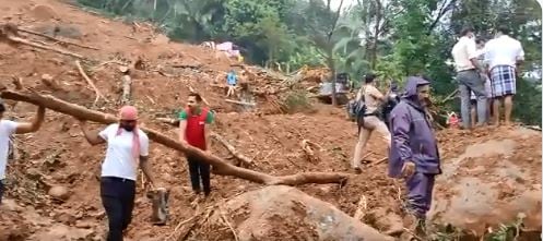 A day after a landslide occured at Kokkayar village in Idukki on Saturday, NDRF personnel are seen rescuing people in the village on October 17, 2021. (ANI Photo)