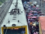 Passengers are seen with umbrellas at a train station in Kolkata. (ANI Photo)