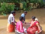 A viral video is floating around the internet, in which the bride Aishwarya and the groom Akash are seen sitting in a round cooking pot, which is being pushed by two men.(ANI on Twitter) A viral video is floating around the internet, in which the bride Aishwarya and the groom Akash are seen sitting in a round cooking pot, which is being pushed by two men.(ANI on Twitter)