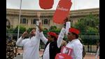 Samajwadi party MLAs fly cutouts of LPG cylinders in the air with balloons during a protest against fuel price hike during the special session of the Legislative Assembly in front of Vidhan Bhavan, in Lucknow on Monday. (ANI Photo)