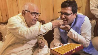 Uttar Pradesh assembly speaker Hriday Narayan Dikshit offers sweets to newly elected deputy speaker Nitin Agarwal at Vidhan Bhavan in Lucknow on Monday. (PTI Photo) Uttar Pradesh assembly speaker Hriday Narayan Dikshit offers sweets to newly elected deputy speaker Nitin Agarwal at Vidhan Bhavan in Lucknow on Monday. (PTI Photo)