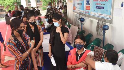 A health worker administers a dose of Covid-19 vaccine to a beneficiary at SKM Hall in Patna. (PTI) A health worker administers a dose of Covid-19 vaccine to a beneficiary at SKM Hall in Patna. (PTI)