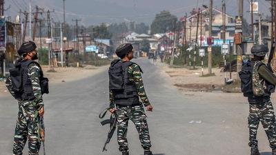 Soldiers stand guard on a road leading towards the site of a gunfight in Kashmir (AP) Soldiers stand guard on a road leading towards the site of a gunfight in Kashmir (AP)