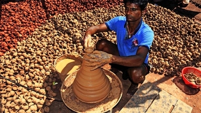 A potter makes earthen diyas in the scorching heat for the festival of lights, Diwali in Ranchi. (ANI) A potter makes earthen diyas in the scorching heat for the festival of lights, Diwali in Ranchi. (ANI)