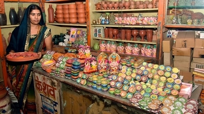 Before Diwali, people clean their houses and make rangolis on the floor. In this still, a woman potter can be seen displaying earthen lamps made using cow dung ahead of the festival in Surat. (ANI) Before Diwali, people clean their houses and make rangolis on the floor. In this still, a woman potter can be seen displaying earthen lamps made using cow dung ahead of the festival in Surat. (ANI)