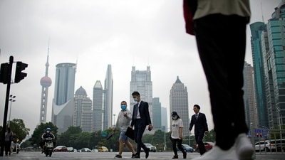 People walk along at financial district of Lujiazui in Shanghai, China. (REUTERS)