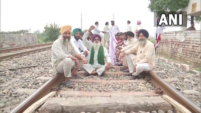 Farm law protestors sit on the railway track at Devi Dasspura village in Amritsar following the farmer's union call for 'Rail Roko Andolan'. (ANI) Farm law protestors sit on the railway track at Devi Dasspura village in Amritsar following the farmer's union call for 'Rail Roko Andolan'. (ANI)