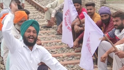 Farm law protestors sit on the railway track at Devi Dasspura village in Amritsar following the farmer's union call for 'Rail Roko Andolan'. (ANI) Farm law protestors sit on the railway track at Devi Dasspura village in Amritsar following the farmer's union call for 'Rail Roko Andolan'. (ANI)