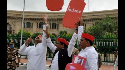 Samajwadi party MLAs fly cutouts of LPG cylinders in the air with balloons during a protest against fuel price hike during the special session of the Legislative Assembly in front of Vidhan Bhavan, in Lucknow on Monday. (ANI Photo)