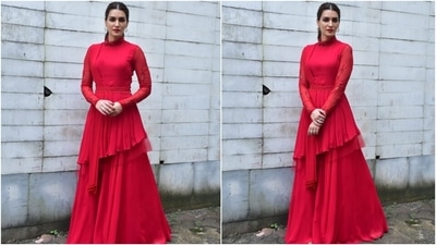 Kriti Sanon chose a bright red bandhgala kurta featuring embroidered full sleeves, an embellished belt cinched on the waist, asymmetric hemline, pleated dupatta with tassels, and a flared silhouette. (HT Photo/Varinder Chawla) Kriti Sanon chose a bright red bandhgala kurta featuring embroidered full sleeves, an embellished belt cinched on the waist, asymmetric hemline, pleated dupatta with tassels, and a flared silhouette. (HT Photo/Varinder Chawla)