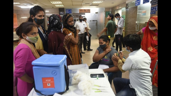 A woman gets a Covid-19 vaccine at the district hospital in Noida’s Sector 30 on Monday. (Sunil Ghosh/HT)