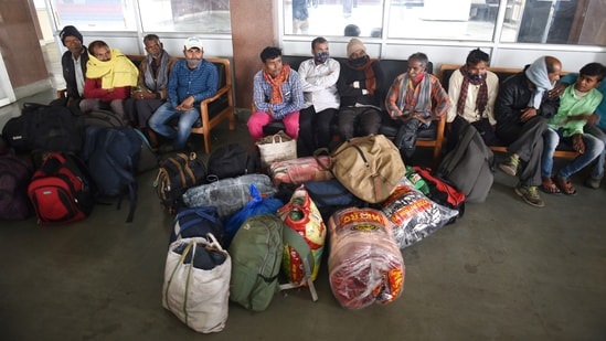 Migrant workers waiting to board a train in Srinagar on Monday.&nbsp;(HT Photo)