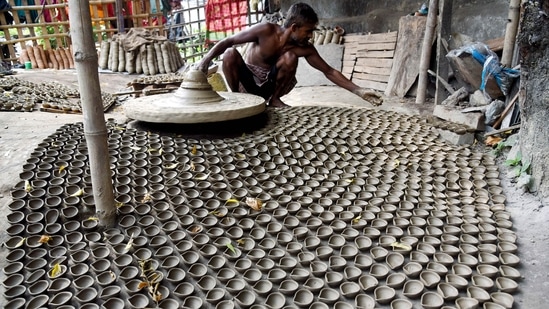 A potter makes earthen lamps for the upcoming Diwali festival in Patna.(ANI)
