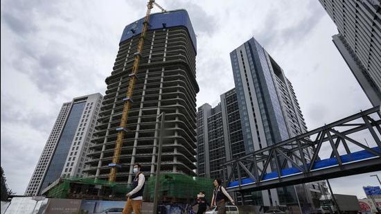 Commercial office buildings under construction in Tongzhou, outskirts of Beijing, China. China’s economy is losing steam as a result of multiple woes, including power shortages and fresh Covid-19 outbreaks. (AP)