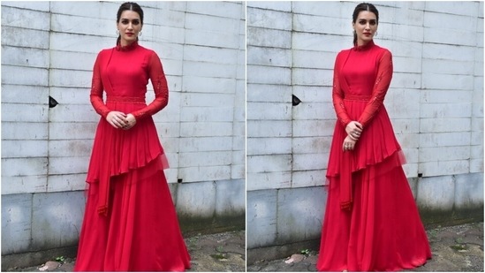 Kriti Sanon chose a bright red bandhgala kurta featuring embroidered full sleeves, an embellished belt cinched on the waist, asymmetric hemline, pleated dupatta with tassels, and a flared silhouette.(HT Photo/Varinder Chawla)