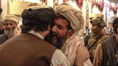Several photos showed Haqqani embracing relatives of the suicide bombers and praying at the meeting. (TWITTER/@Saeed Khosty.) Several photos showed Haqqani embracing relatives of the suicide bombers and praying at the meeting. (TWITTER/@Saeed Khosty.)