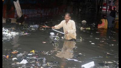 A commuter struggles to cross a waterlogged road after heavy rainfall, in Agra on Monday. (ANI Photo) A commuter struggles to cross a waterlogged road after heavy rainfall, in Agra on Monday. (ANI Photo)