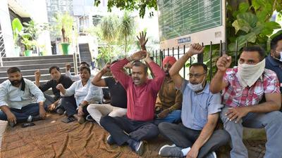 BJP district secretary Lucky Chopra along with other party members staging a protest outside the Ludhiana Improvement Trust office on Tuesday. (Gurpreet Singh/HT) BJP district secretary Lucky Chopra along with other party members staging a protest outside the Ludhiana Improvement Trust office on Tuesday. (Gurpreet Singh/HT)