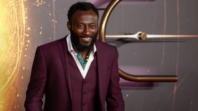 Babs Olusanmokun smiles as he arrives at the screening of Dune. (REUTERS) 