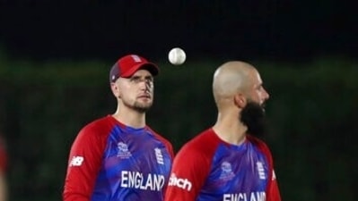 England's Liam Livingstone, left, tosses the ball as he walks with teammate Moeen Ali. (AP)