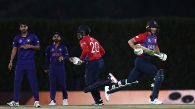 India's bowler Bhuvneshwar Kumar, left, watches on as England's Jason Roy, middle, and teammate Jos Buttler run between the wickets during the Cricket Twenty20 World Cup warm-up match between England and India in Dubai, UAE, Monday, Oct. 18, 2021. (AP Photo/Aijaz Rahi) (AP) India's bowler Bhuvneshwar Kumar, left, watches on as England's Jason Roy, middle, and teammate Jos Buttler run between the wickets during the Cricket Twenty20 World Cup warm-up match between England and India in Dubai, UAE, Monday, Oct. 18, 2021. (AP Photo/Aijaz Rahi) (AP)