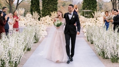 Jennifer, a medical student, shared a candid moment from the wedding on her Instagram. She marked the photo with the date of her marriage and an infinity symbol. "My universe 10.16.21," she captioned the post. (Instagram/@jenniferkgates) Jennifer, a medical student, shared a candid moment from the wedding on her Instagram. She marked the photo with the date of her marriage and an infinity symbol. "My universe 10.16.21," she captioned the post. (Instagram/@jenniferkgates)