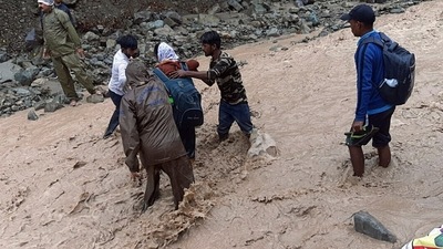 Police personnel rescue stranded devotees who were going to Shri Maa Poornagiri Darshan, amid heavy rains, in Uttarakhand on Monday. (ANI Photo) Police personnel rescue stranded devotees who were going to Shri Maa Poornagiri Darshan, amid heavy rains, in Uttarakhand on Monday. (ANI Photo)
