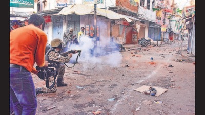 Policemen fire teargas shells on people during an Eid-e-Milad un Nabi procession in Jabalpur on Tuesday (PTI) Policemen fire teargas shells on people during an Eid-e-Milad un Nabi procession in Jabalpur on Tuesday (PTI)