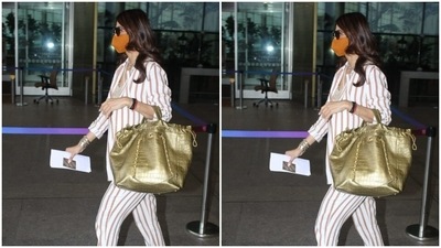 The fashionista, all masked up, chose golden juttis as footwear and carried a bag. (HT Photos/Varinder Chawla) The fashionista, all masked up, chose golden juttis as footwear and carried a bag. (HT Photos/Varinder Chawla)