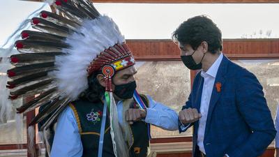Prime Minister Justin Trudeau greets Chief Michael LeBourdais as he visits the Tk'emlups the Sewepemc in Kamloops, British Columbia on Monday. The Canadian PM apologised to the indigenous community for holidaying on September 30. (AP) Prime Minister Justin Trudeau greets Chief Michael LeBourdais as he visits the Tk'emlups the Sewepemc in Kamloops, British Columbia on Monday. The Canadian PM apologised to the indigenous community for holidaying on September 30. (AP)