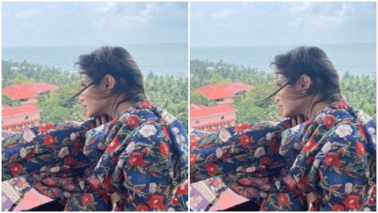 In a blue salwar suit, printed with red and white floral motifs, Mouni posed by a balcony.(Instagram/@imouniroy)